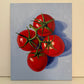 Four Tomatoes on Blue